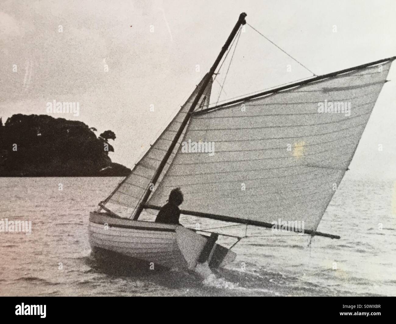 Sailing a small wooden gaff rigged boat to windward Stock Photo
