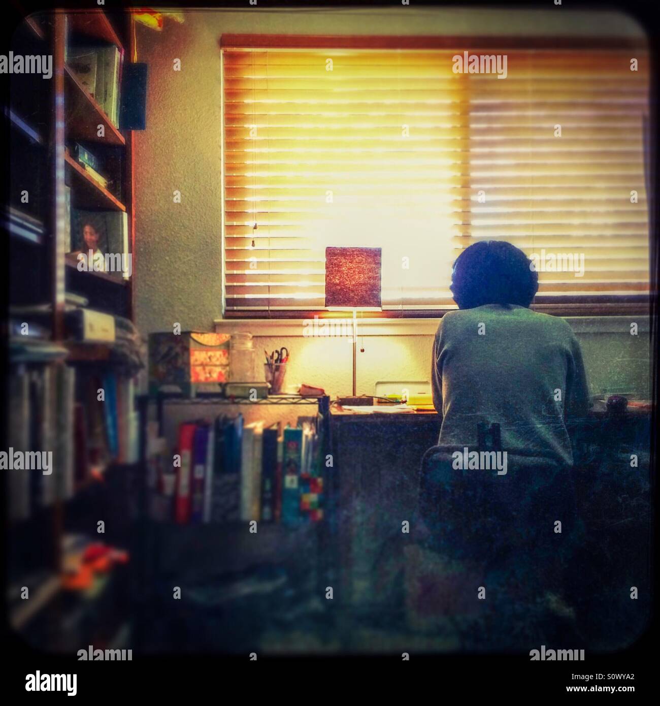 An Asian woman works from home in her office. - Smartphone Captured Stock Image