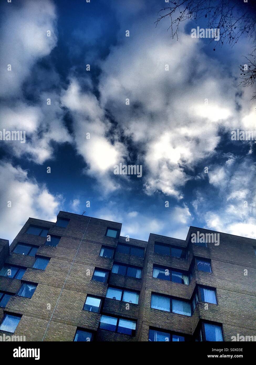 Block of London flats against dramatic sky Stock Photo