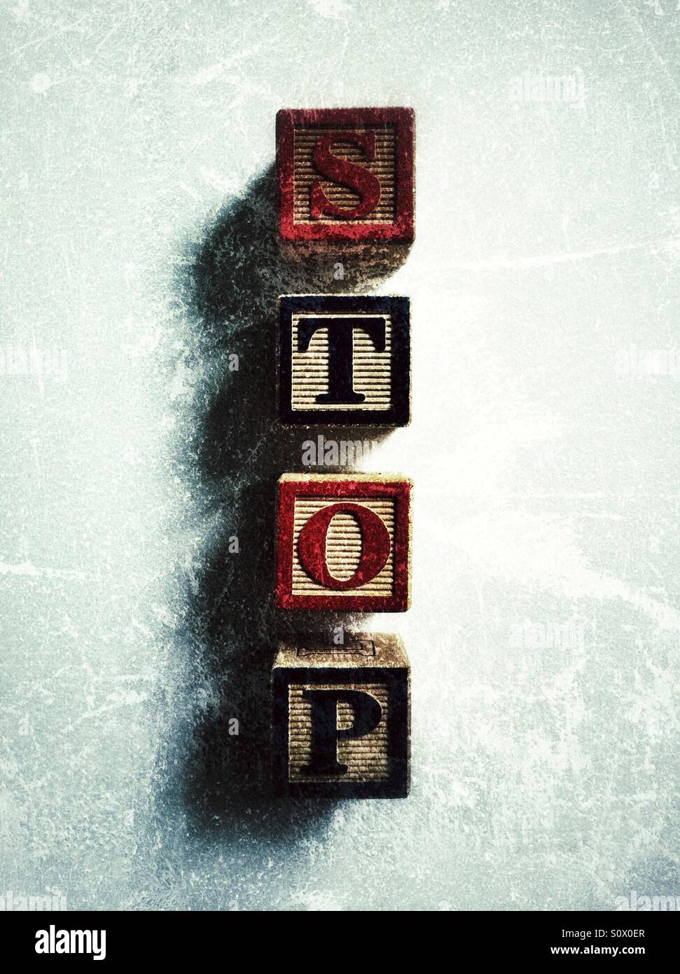 Toy bricks on white background spelling the word stop - Smartphone Captured Stock Image