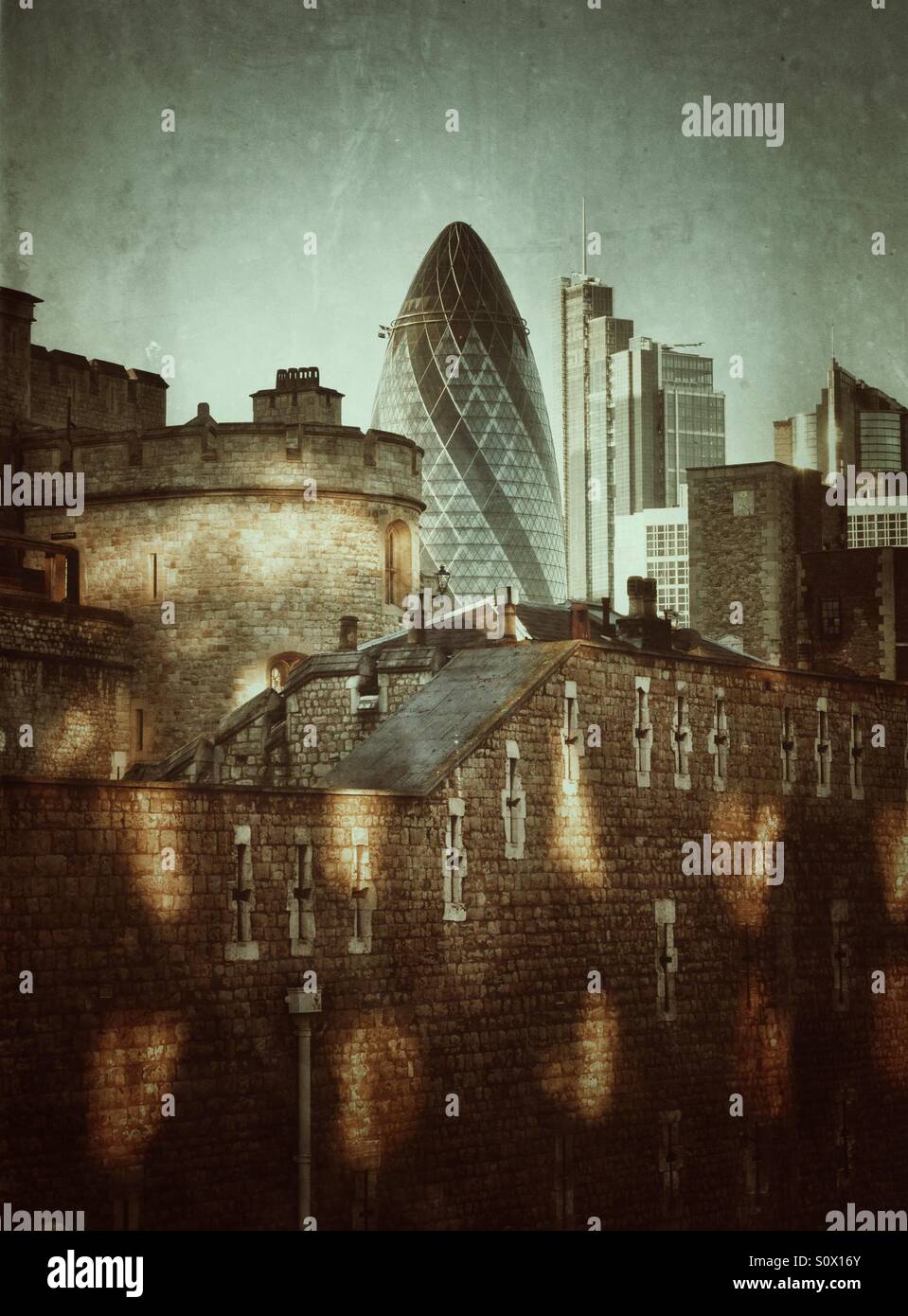 Tower of London in the foreground with skyscraper known as 'The Gherkin' in the background - past and present in London - Smartphone Captured Stock Image