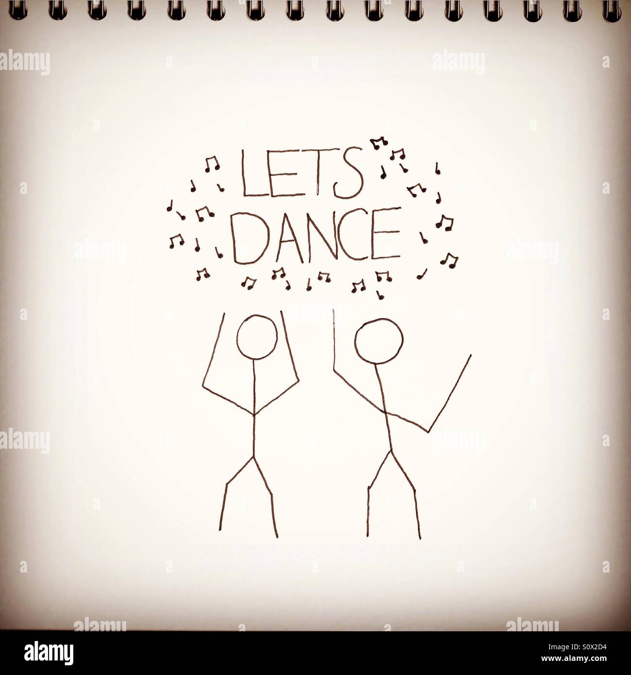 Sketch book with stick men drawing and the quote 'let's dance' - Smartphone Captured Stock Image