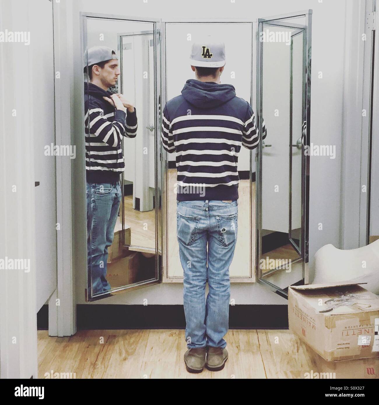 Man in dressing room mirror - Smartphone Captured Stock Image