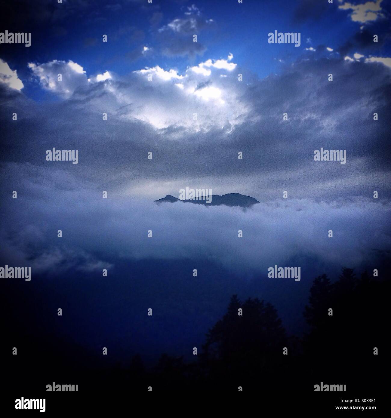 The Cerro del Venado mountain surrounded by clouds in El Triunfo Biosphere Reserve in Chiapas, Mexico - Smartphone Captured Stock Image