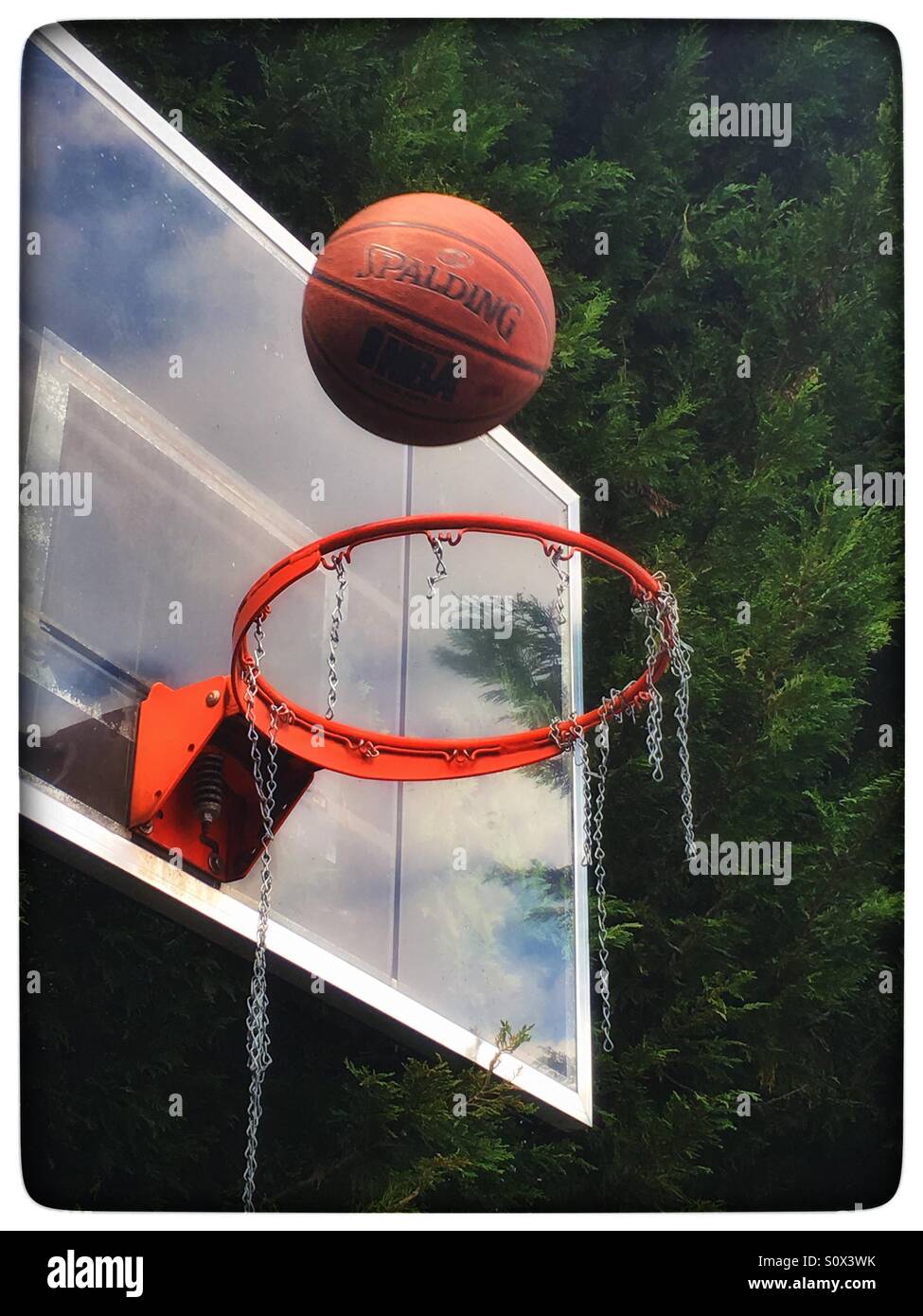 Basketball shot into basketball hoop Stock Photo Alamy
