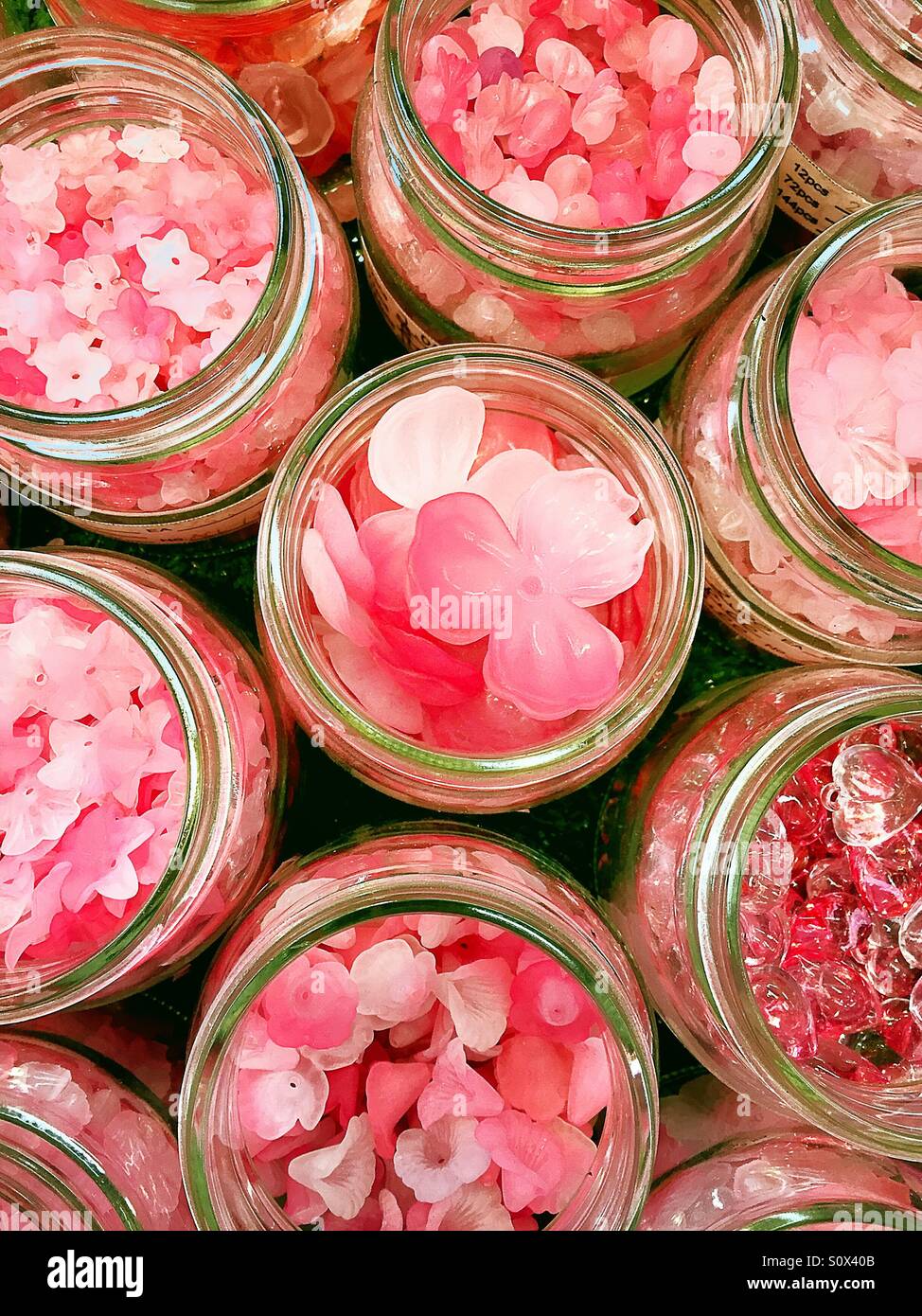 Glass jars of pink plastic beads - Smartphone Captured Stock Image