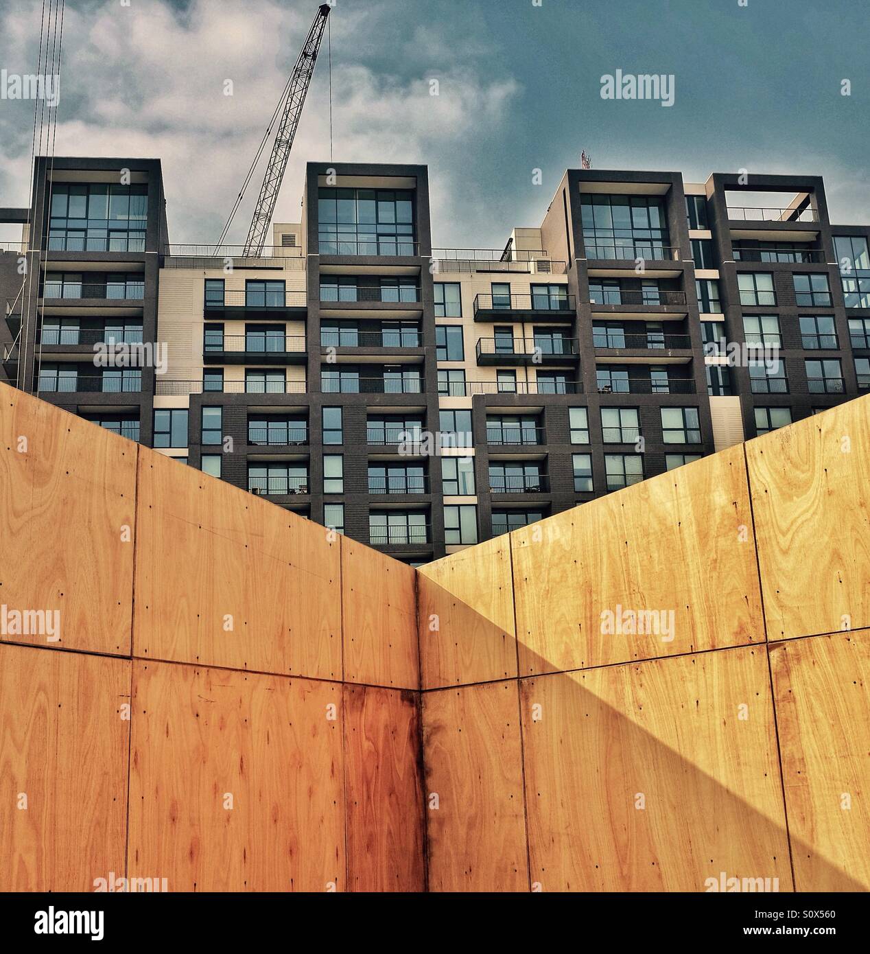 New apartment building protected by a wooden barrier Stock Photo Alamy