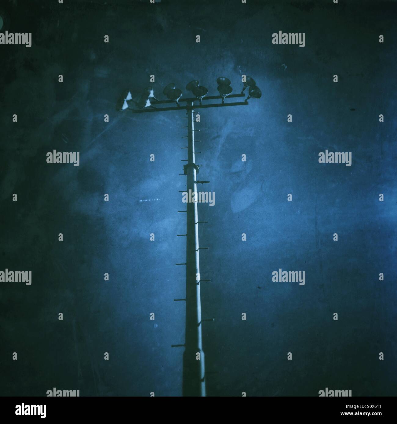 Light pole on an athletic field with stormy skies - Smartphone Captured Stock Image