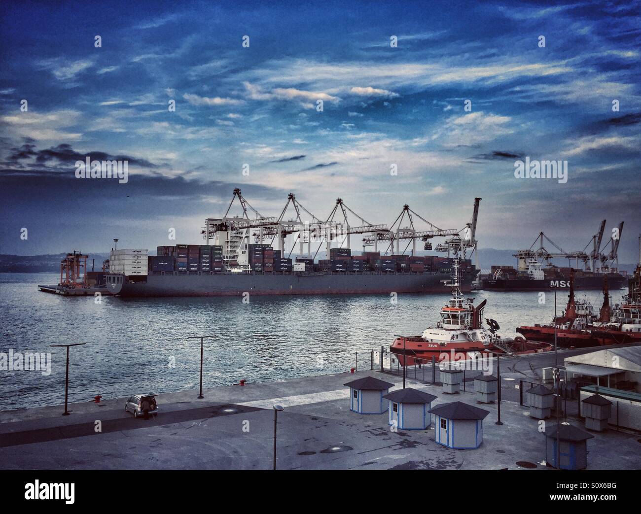 Container ship loading at the shipping yard in Port of Koper, Slovenia - Smartphone Captured Stock Image