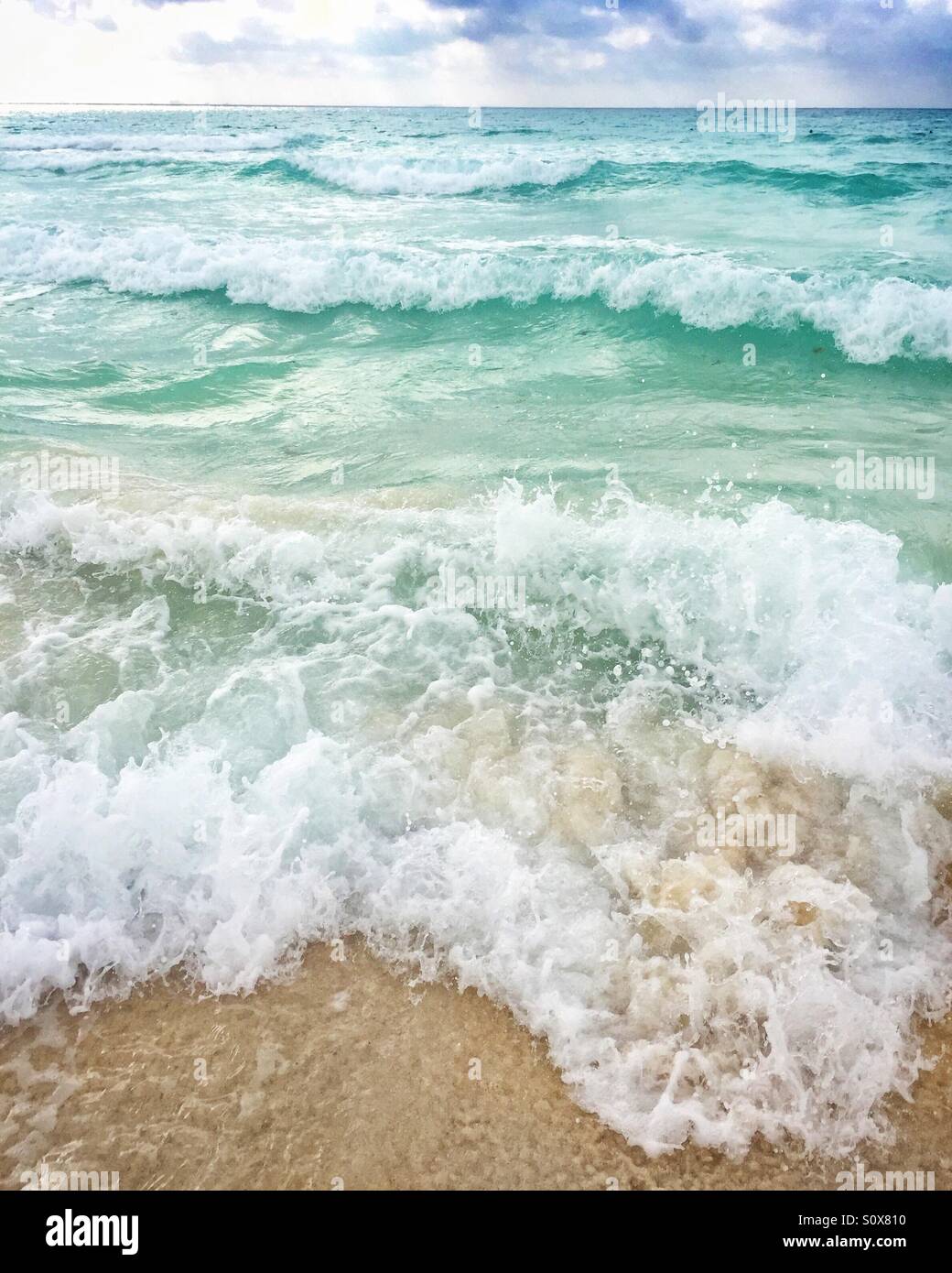 Waves breaking on sandy beach in playa del Carmen Mexico - Smartphone Captured Stock Image