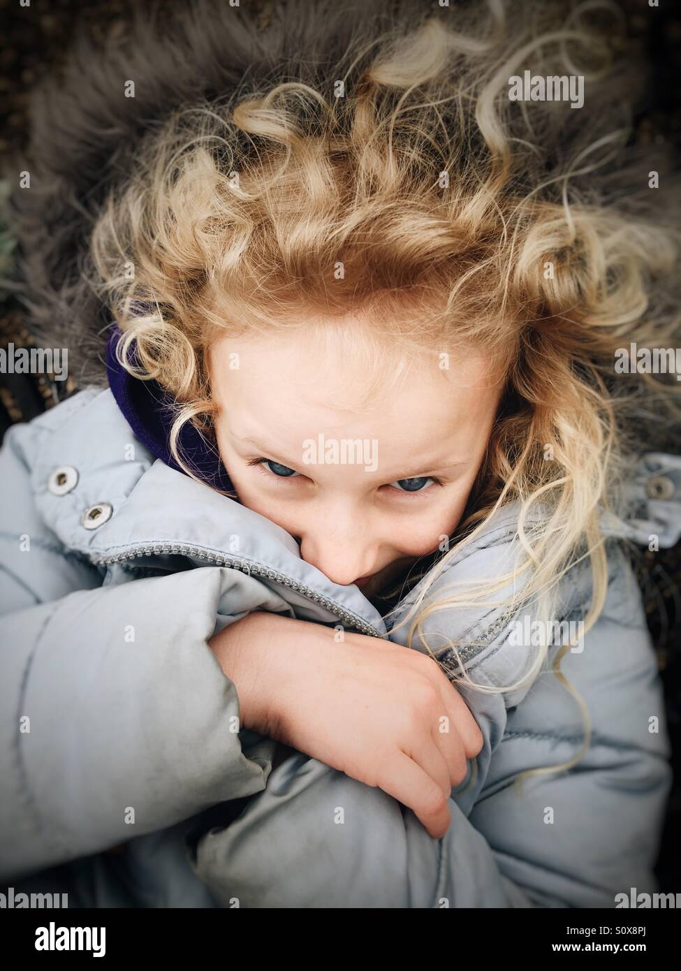 Young girl snug in her warm winter coat Stock Photo