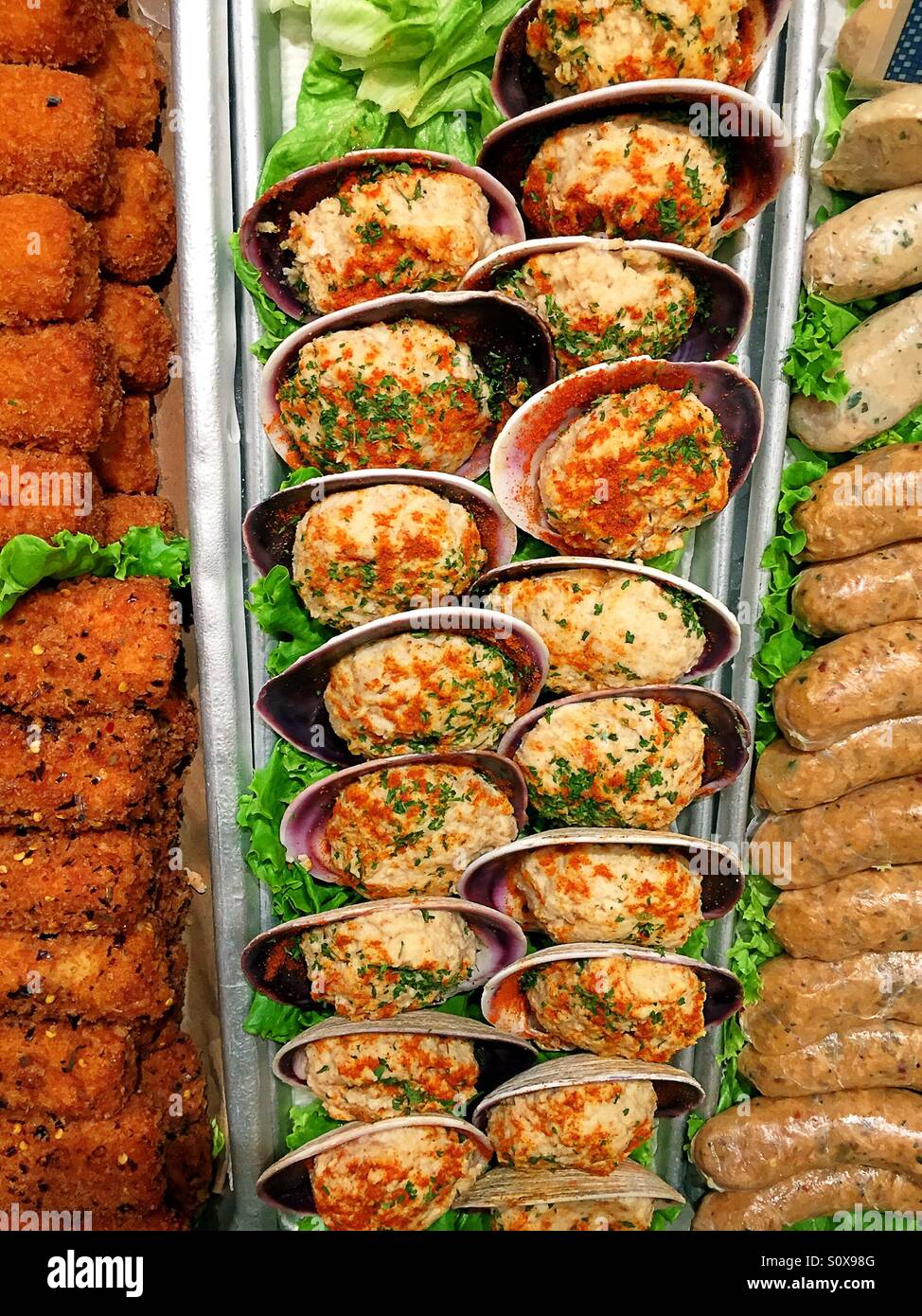 Baked clams for sale in fish monger display - Smartphone Captured Stock Image