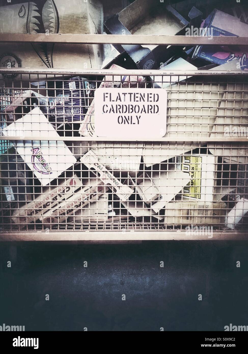 Cardboard recycling bin for flattened boxes. Most of these boxes are not flat. - Smartphone Captured Stock Image