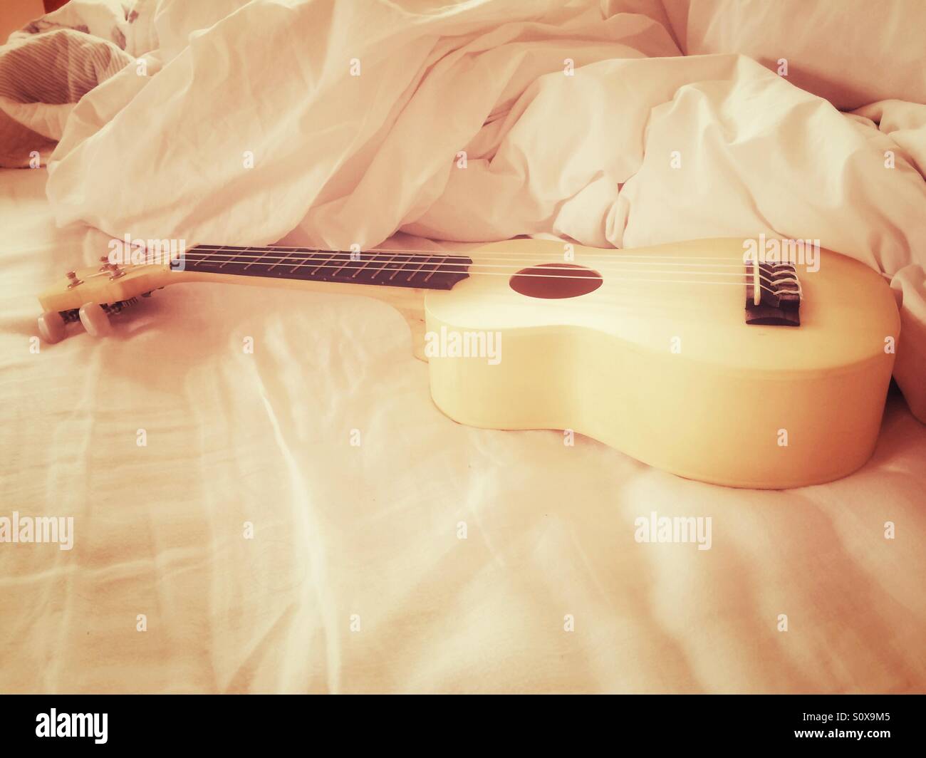 Ukulele in bed Stock Photo - Alamy