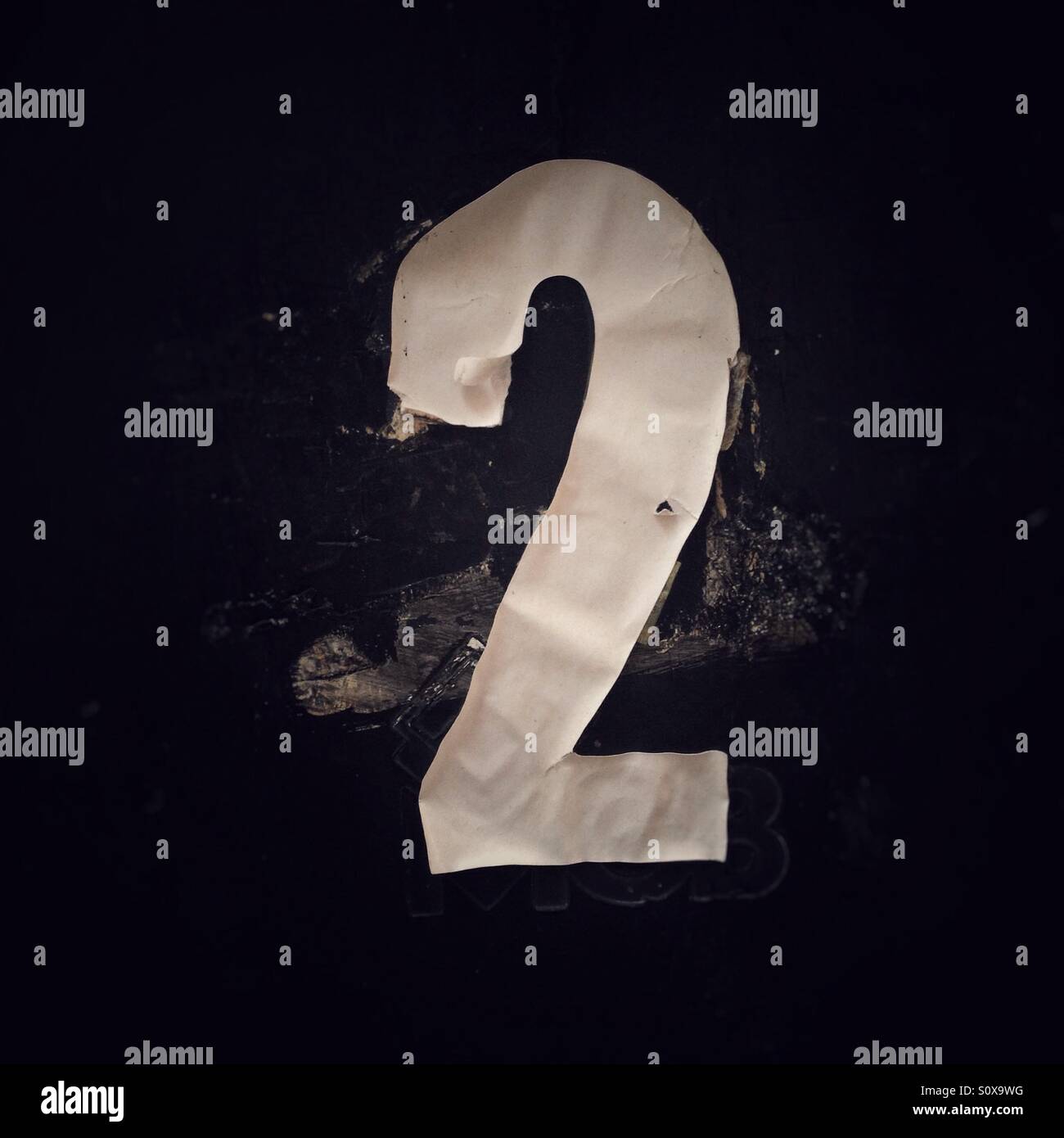 Scrappy tatty stuck-on number 2. - Smartphone Captured Stock Image