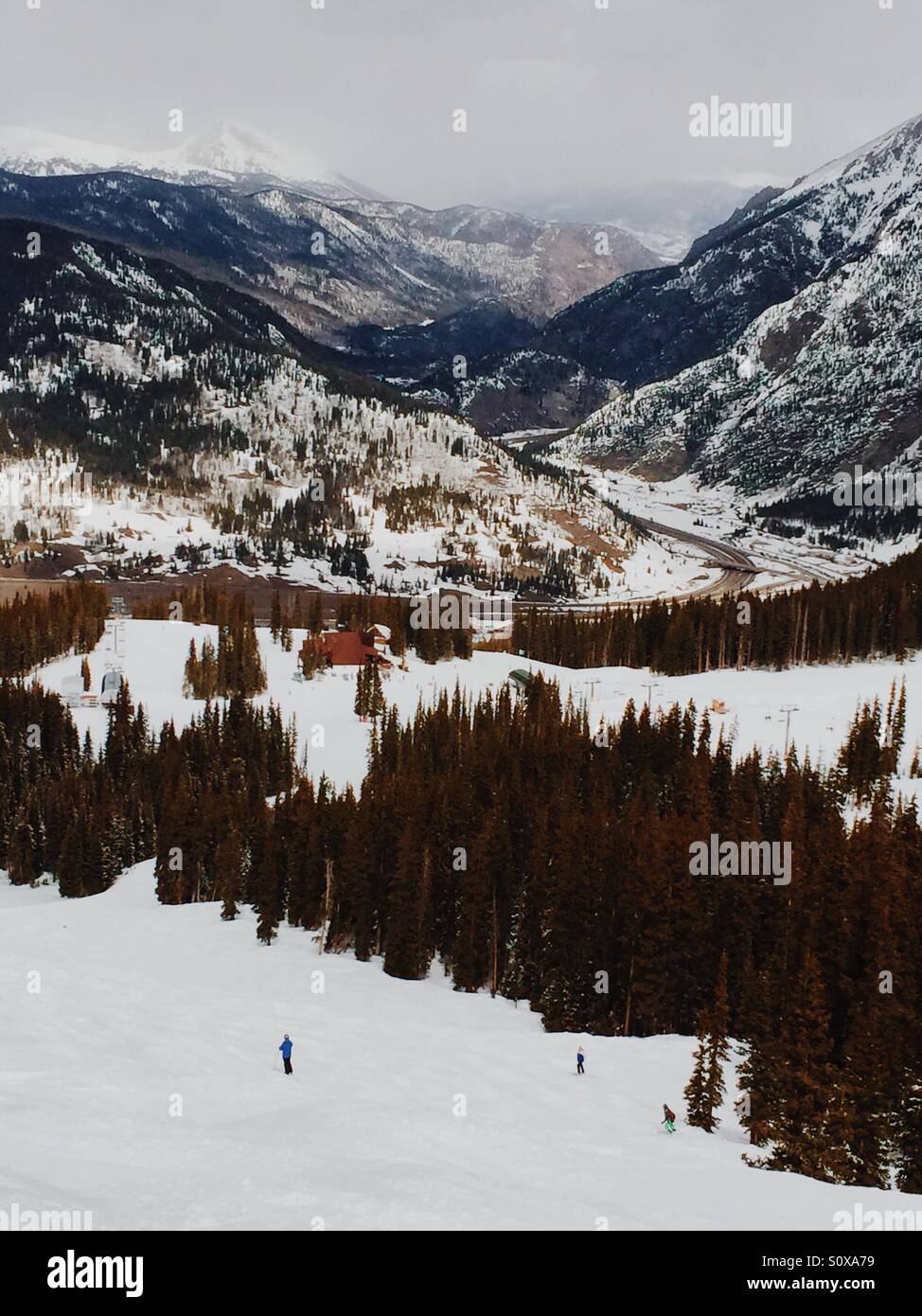 Copper Mountain Ski Area, Colorado. 9 March 2016 - Skiers navigate through moguls from the top of the Hallelujah Ski Run at Copper Mountain Ski Resort as a storm rolls in along the Continental Divide. - Smartphone Captured Stock Image