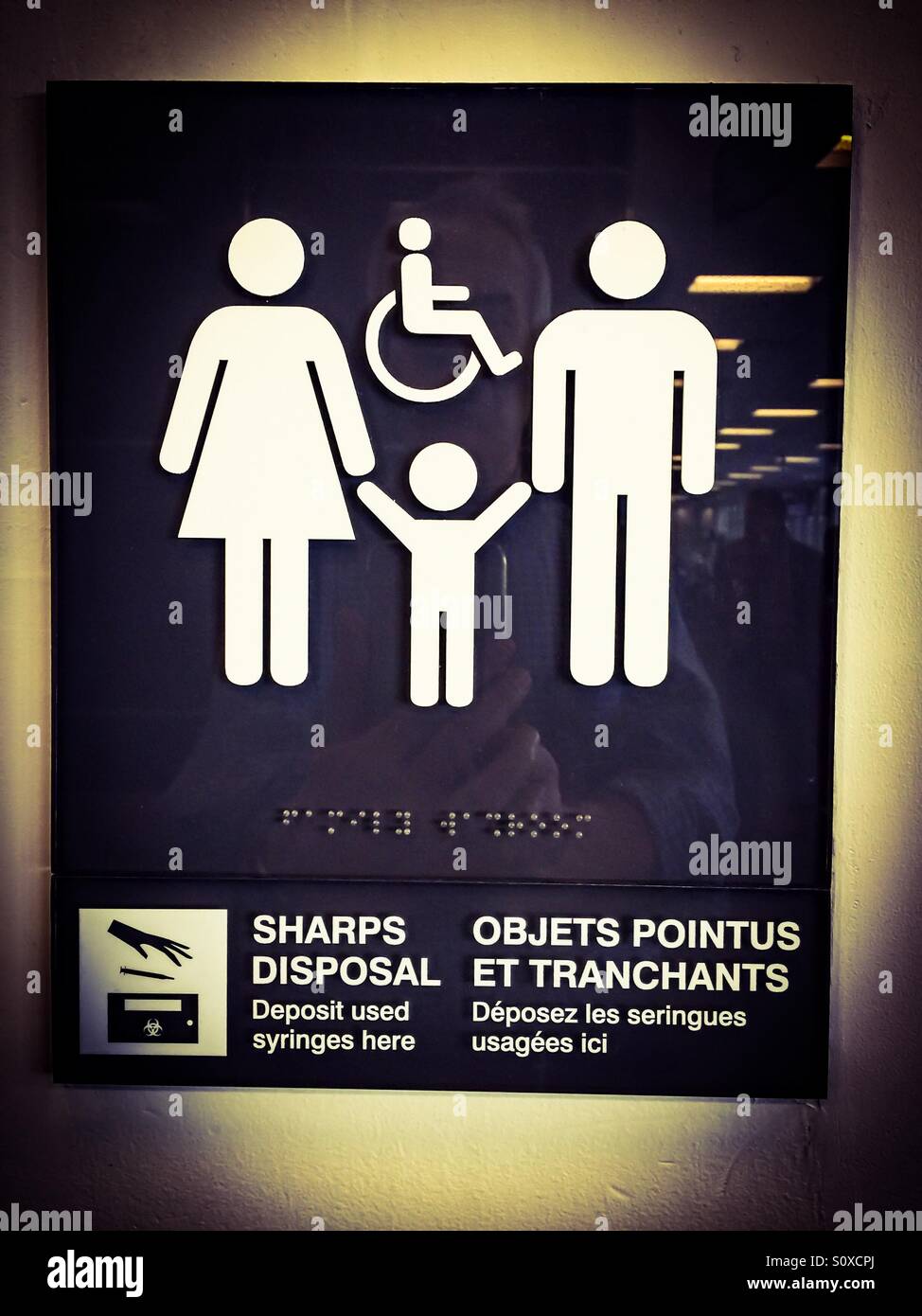 All inclusive washroom sign, all genders, children, grownups, bilingual, Braille readable, needle disposal Stock Photo