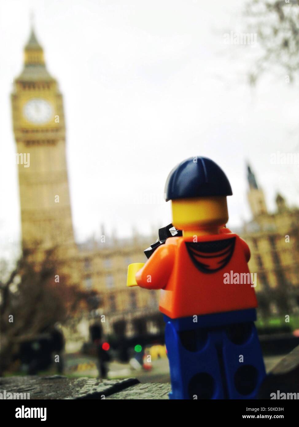 Lego figure taking a picture of the James Tower, Big ben, London, England Stock Photo