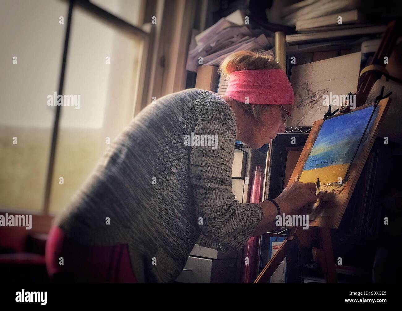 Artist painting in acrylic colours using a pallette knife - Smartphone Captured Stock Image