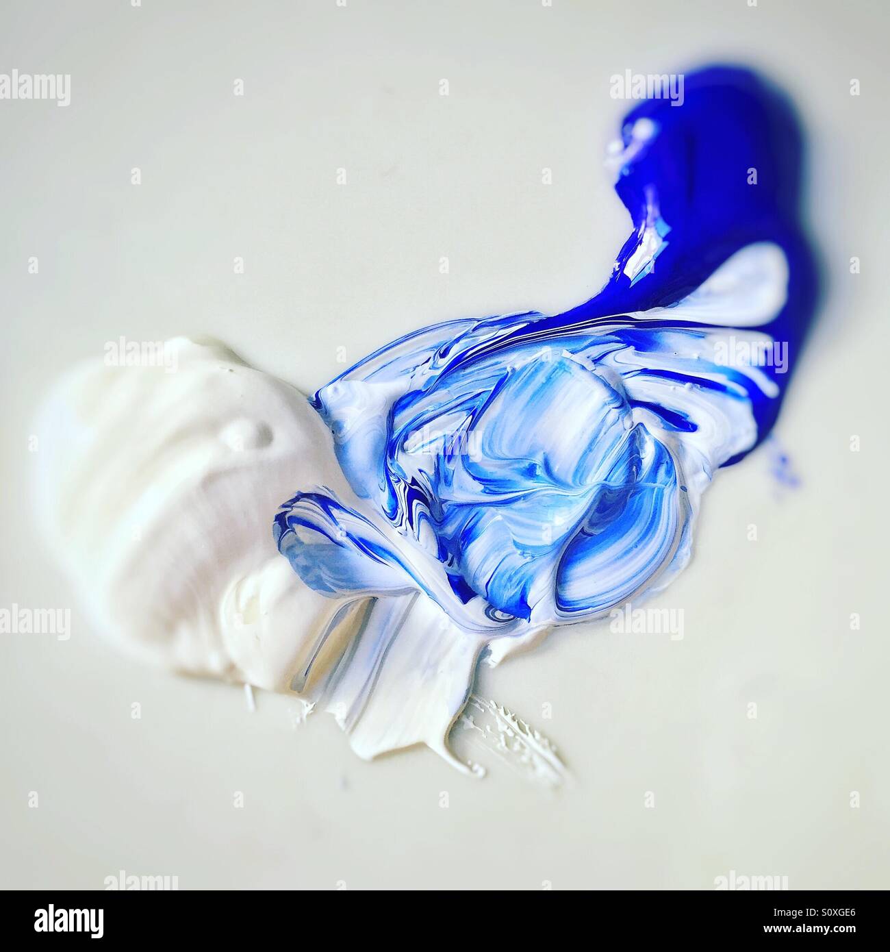 Mixing blue and white acrylic paints - Smartphone Captured Stock Image