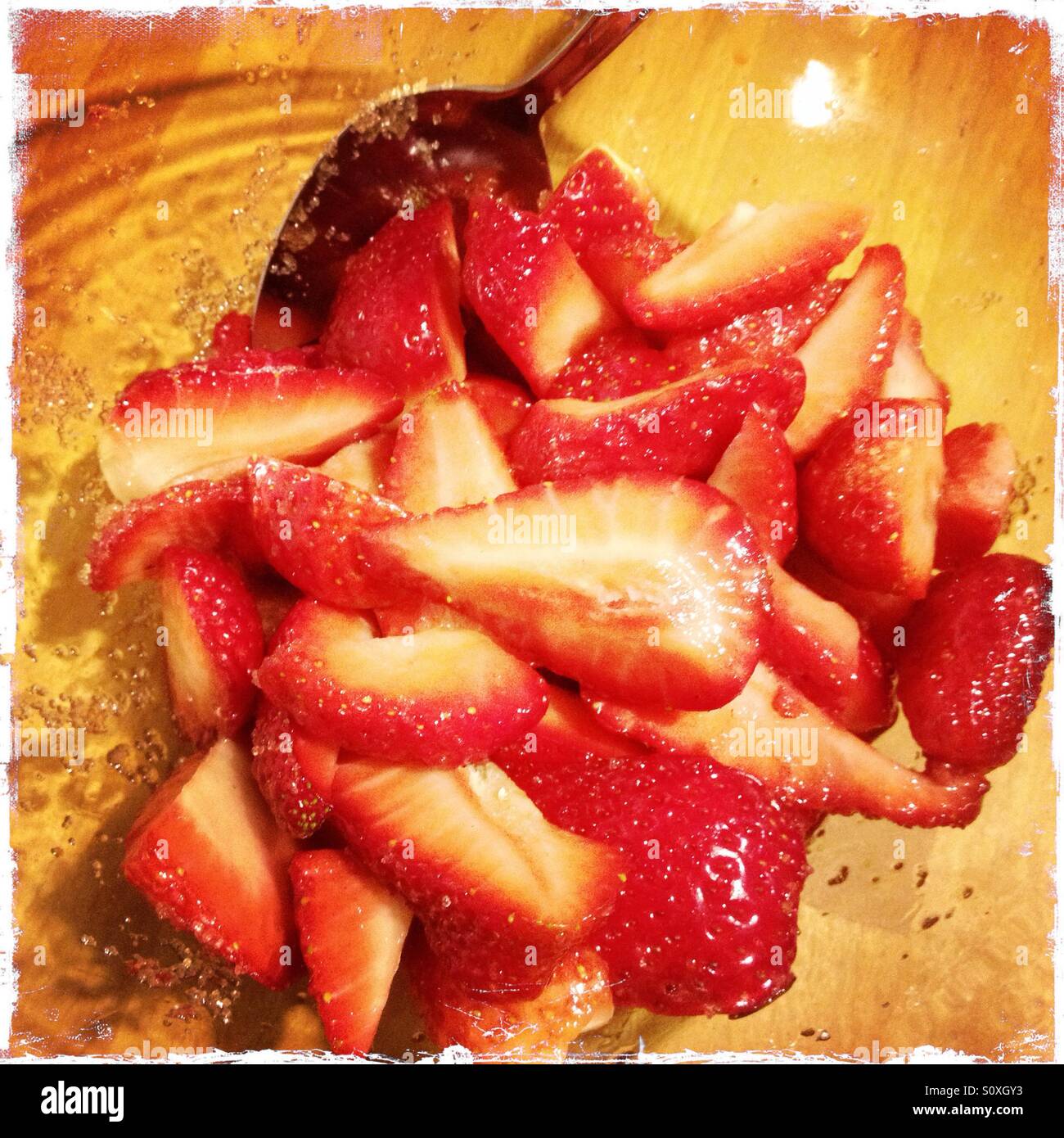 A bowl of cut strawberries and sugar - Smartphone Captured Stock Image