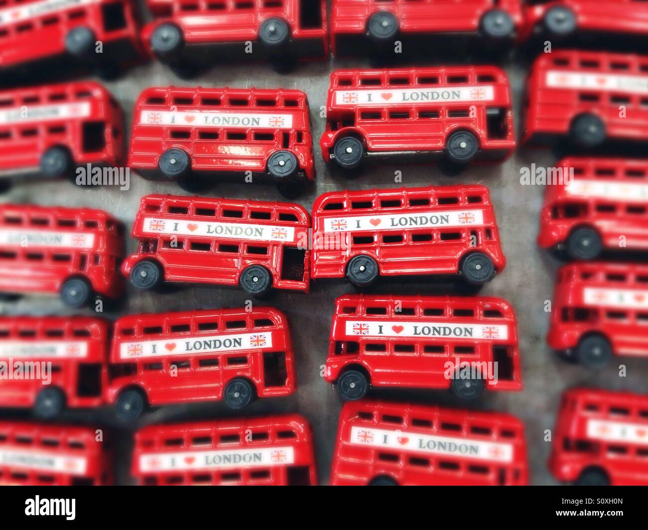 Red busses sold as souvenirs in Camden Town, London, UK - Smartphone Captured Stock Image
