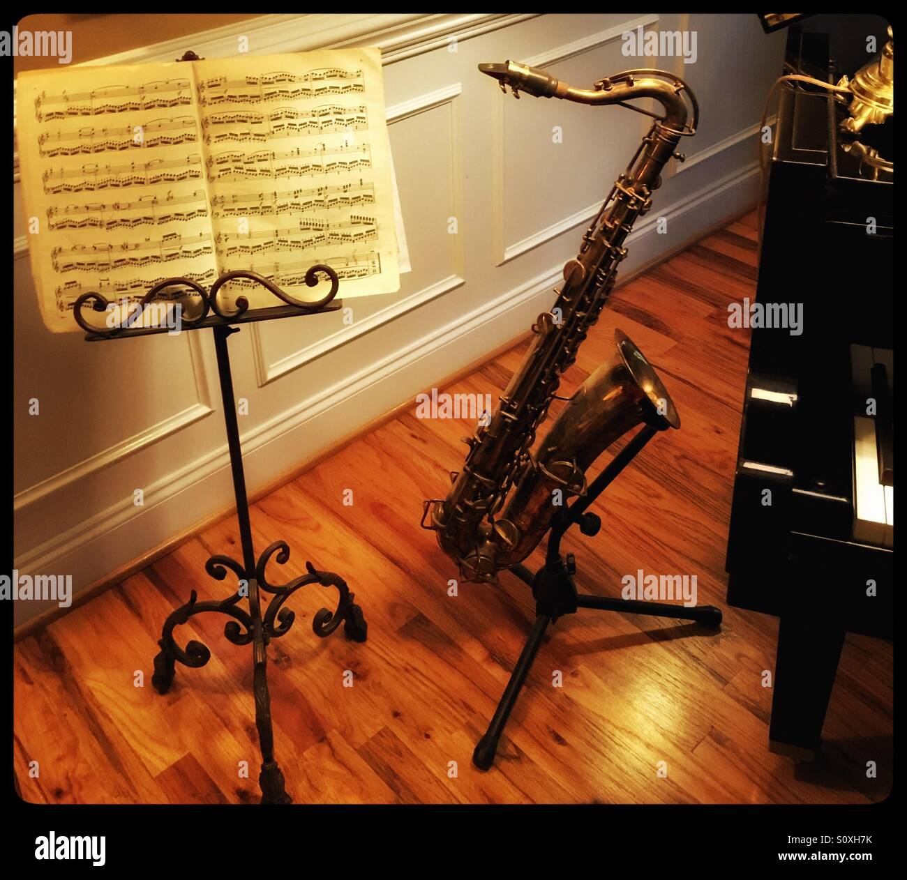 Antique saxophone standing next to music stand Stock Photo Alamy