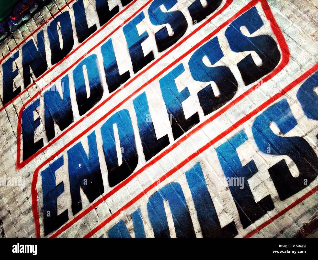 Graffiti by endless mimicking snickers Design on a wall in Brick Lane, Shoreditch, London, England Stock Photo