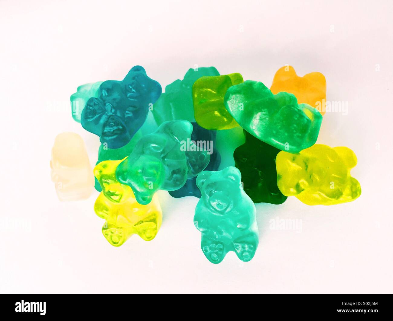 Close up view of a handful of gummy bear candy on white background - Smartphone Captured Stock Image