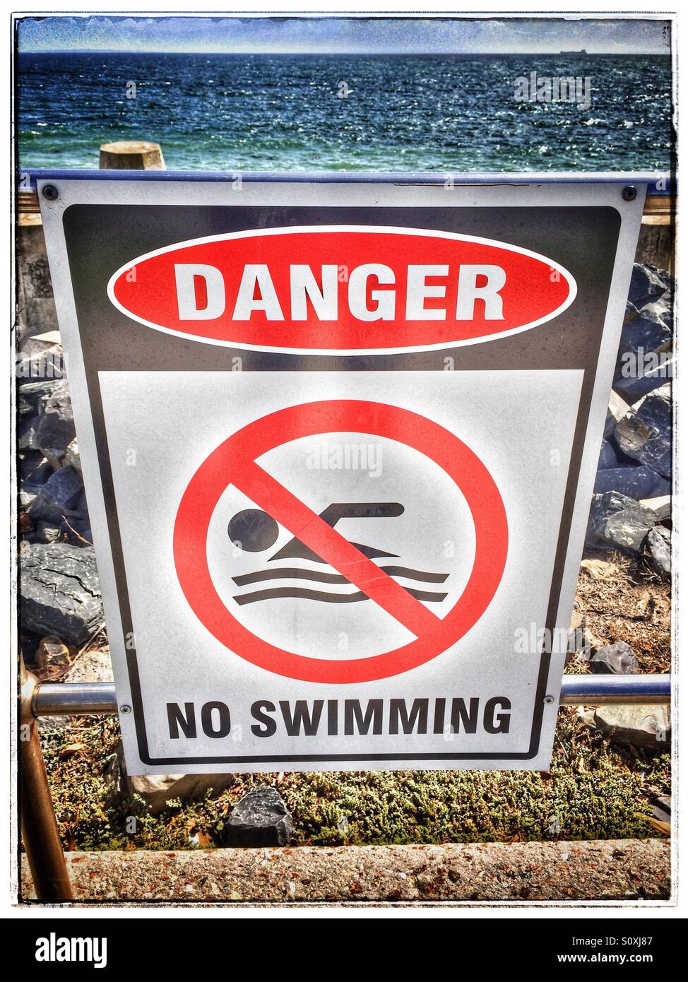 Public safety sign ' danger no swimming'. - Smartphone Captured Stock Image