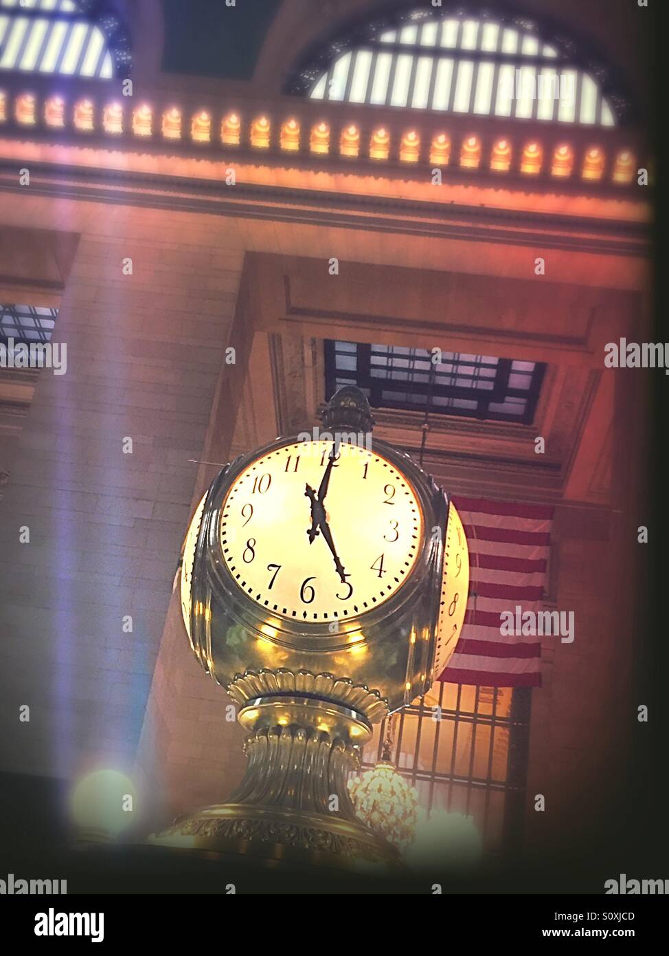 The huge four sided clock in the center of Grand Central concourse registers 5 o'clock Stock