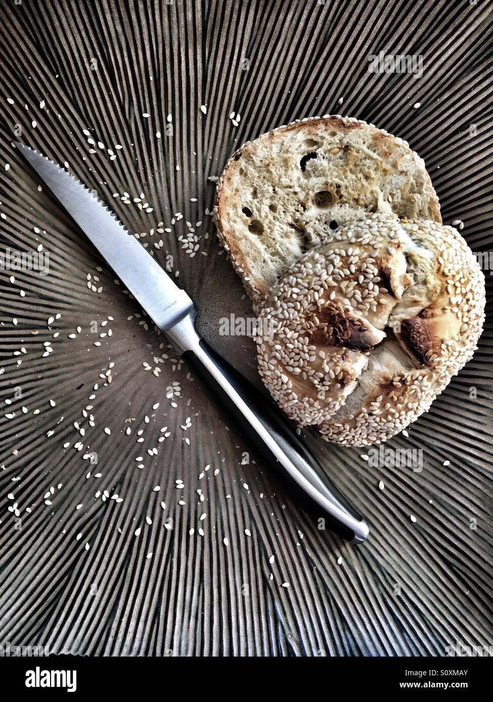 Seeded bagel on a plate Stock Photo