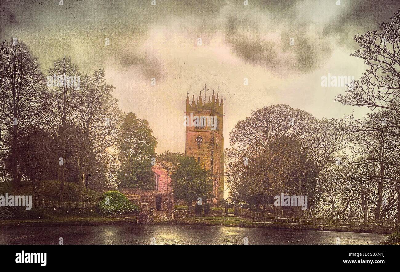 Country Church infront of pond, surrounded by trees against a dramatic sky. Gawsworth St James the Great. Cheshire. Stock Photo