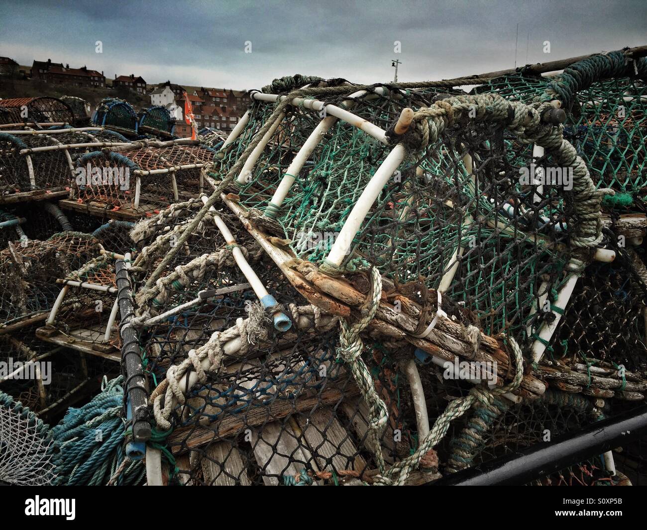 Lobster pots, stacked on the harbour side - Smartphone Captured Stock Image