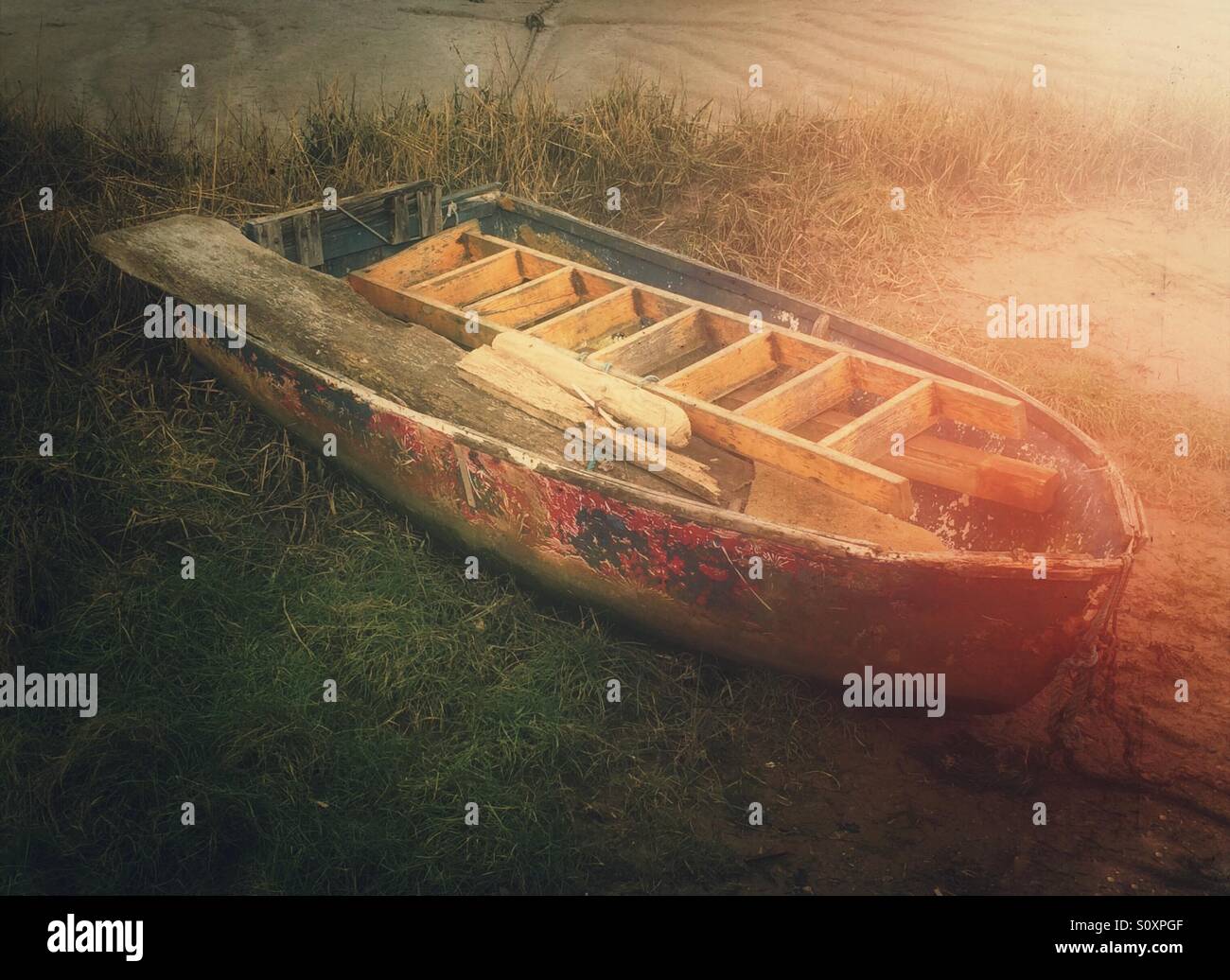 Small boat on the bank of the river with a ladder and timber inside. - Smartphone Captured Stock Image