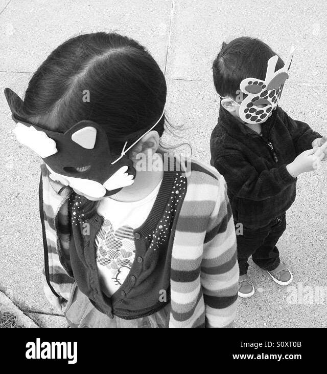Black and white masked children Stock Photo