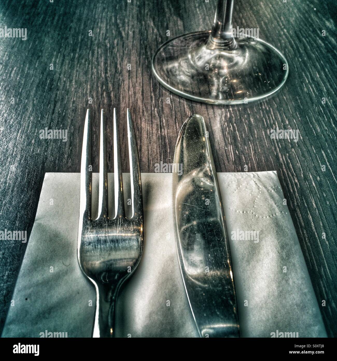 Knife, fork, serviette and glass Stock Photo