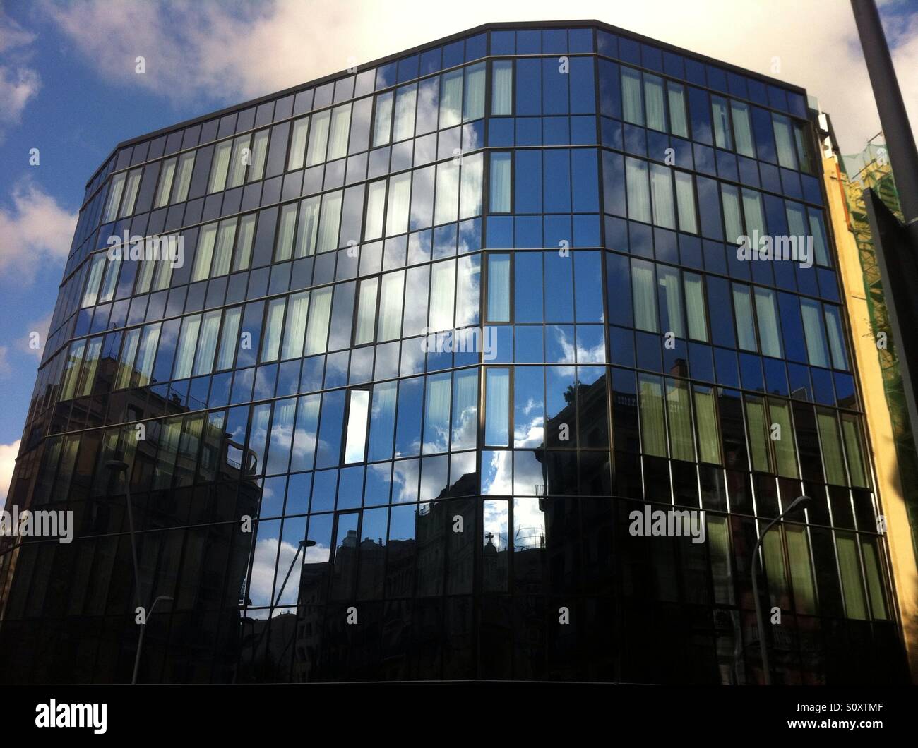 Blue sky reflected on building facade - Smartphone Captured Stock Image