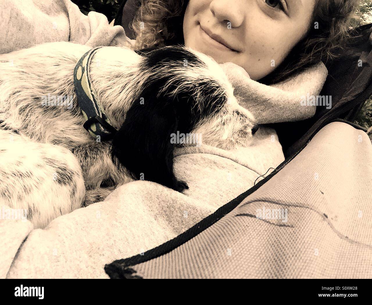 Girl holding sleepy puppy - Smartphone Captured Stock Image