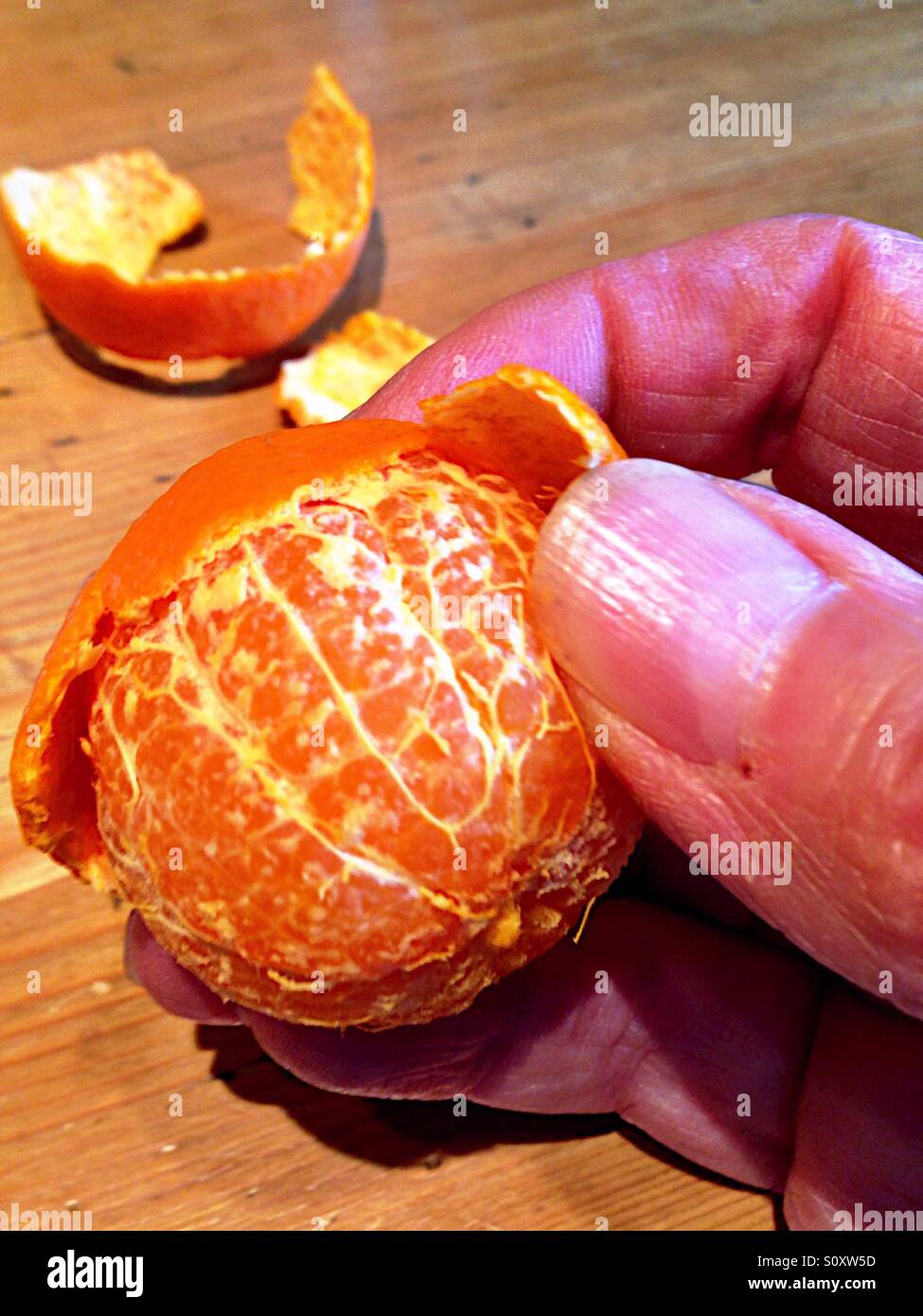 Peeling a tangerine - Smartphone Captured Stock Image