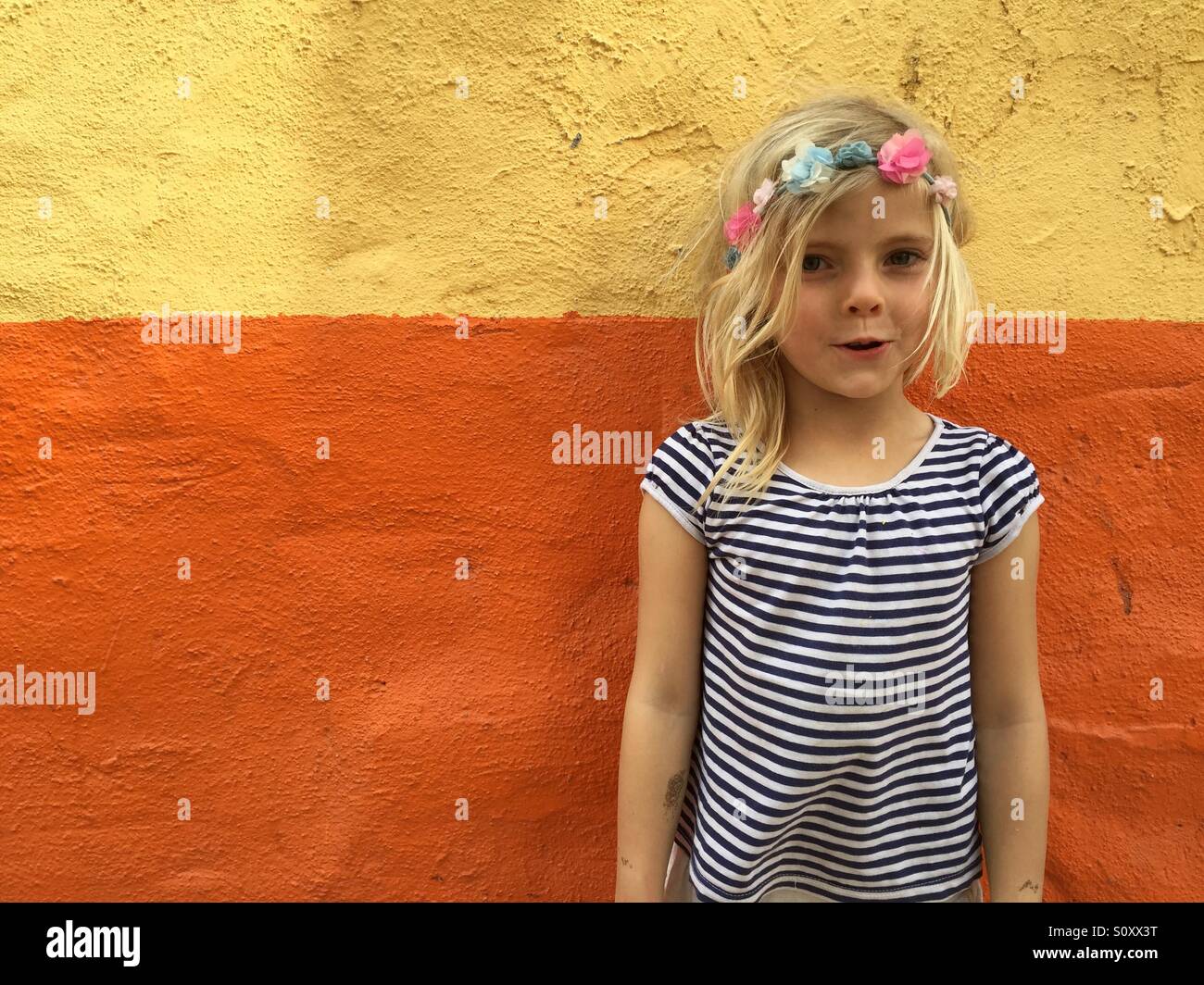 Girl in front of a colourful wall Stock Photo