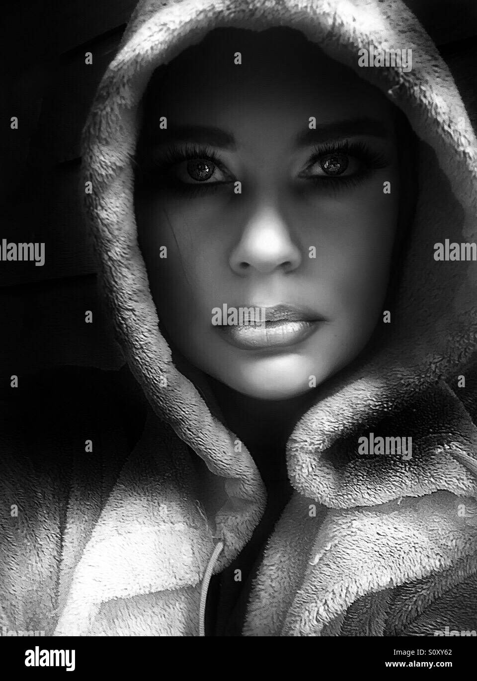 Black and white portrait of hooded woman Stock Photo