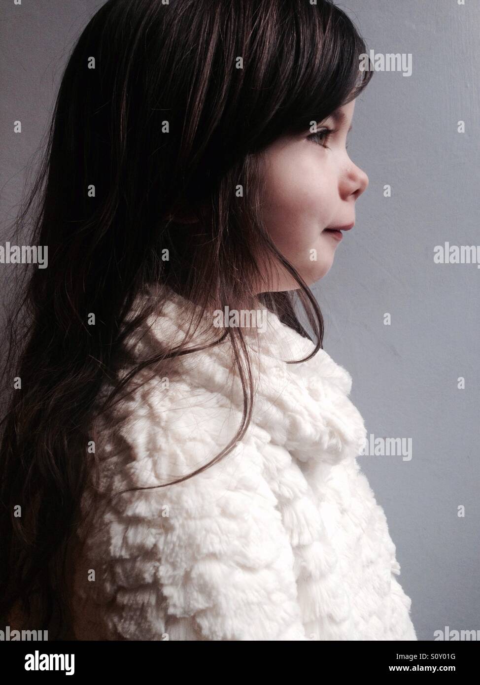 4-year old English girl wearing white fluffy jacket - Smartphone Captured Stock Image