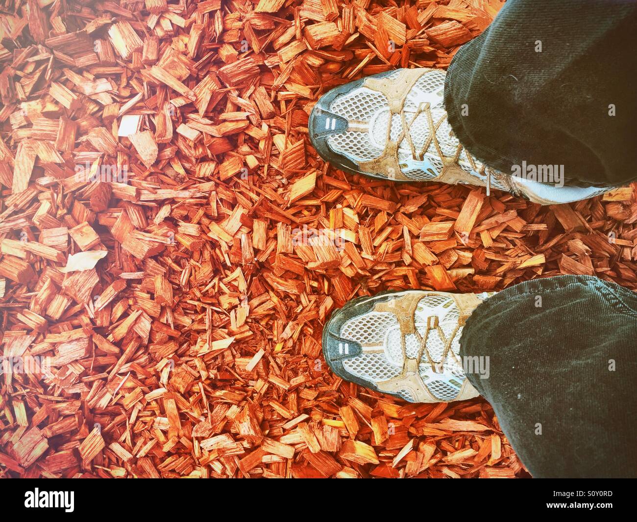 Walking boots on a carpet of chipped wood - Smartphone Captured Stock Image