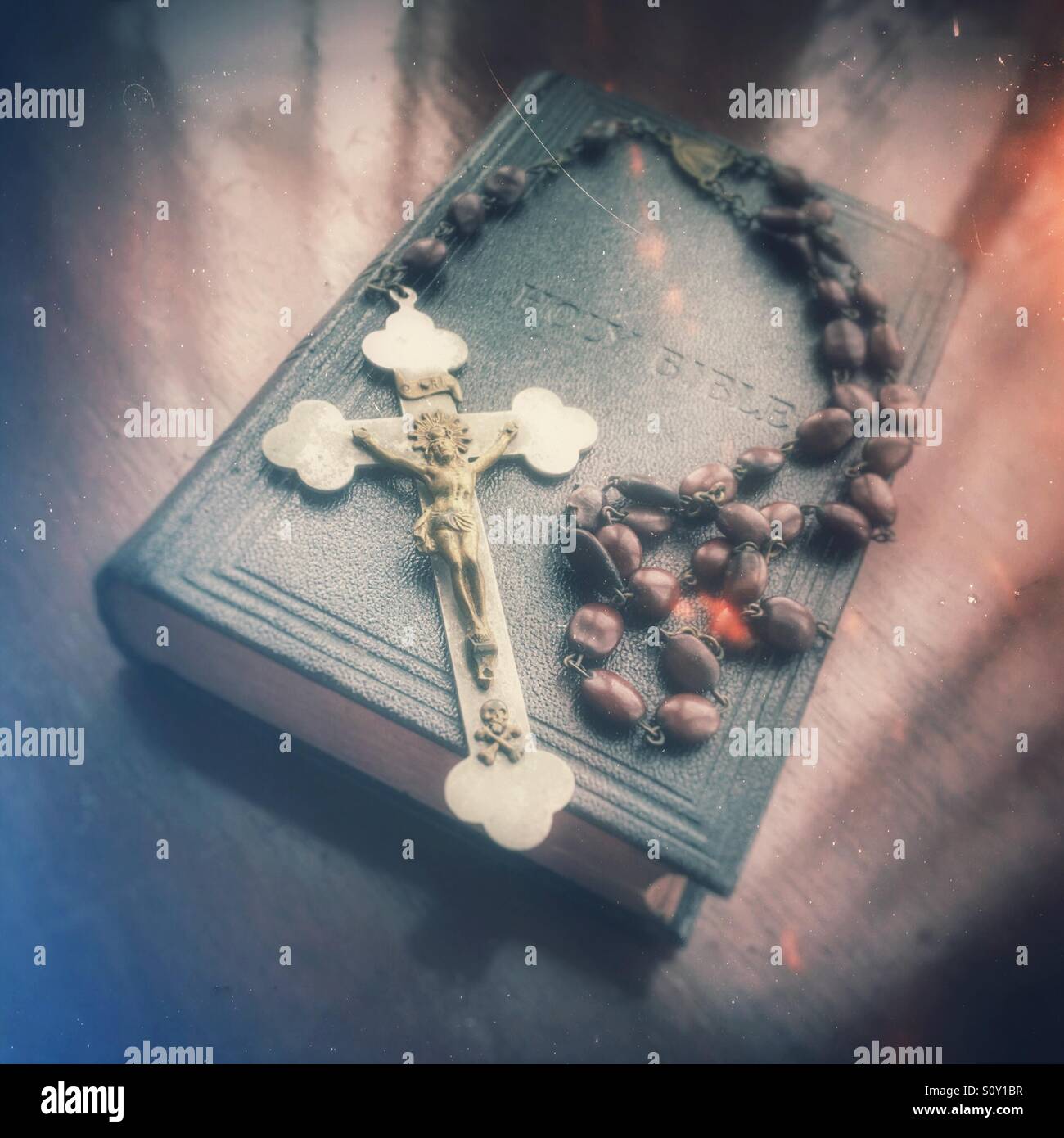Rosary beads and bible resting on holy bible Stock Photo Alamy