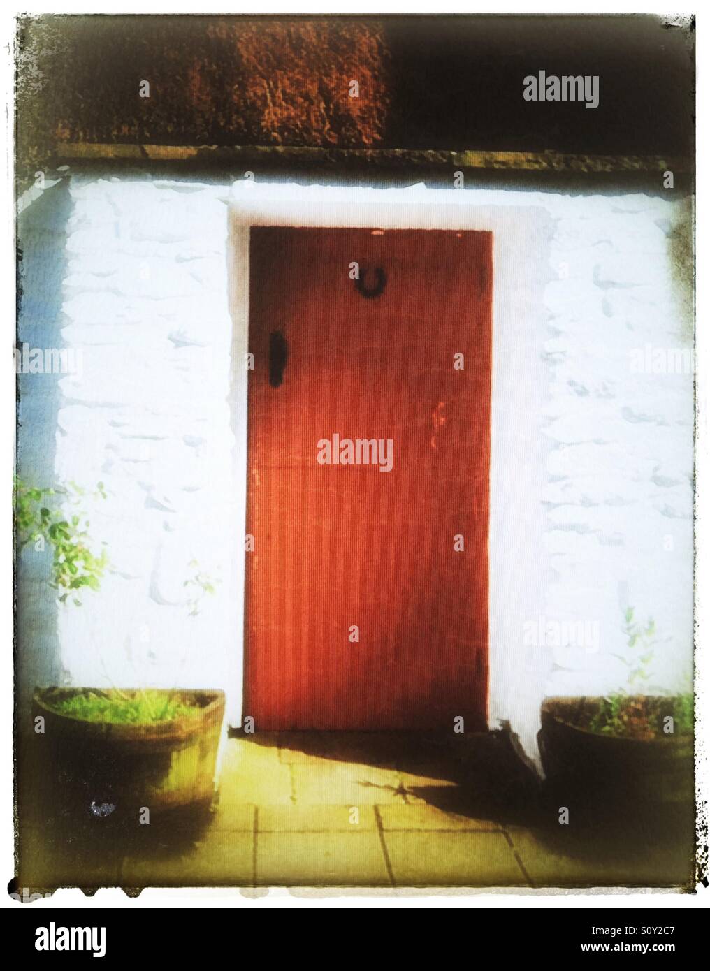 Red door on white building Stock Photo