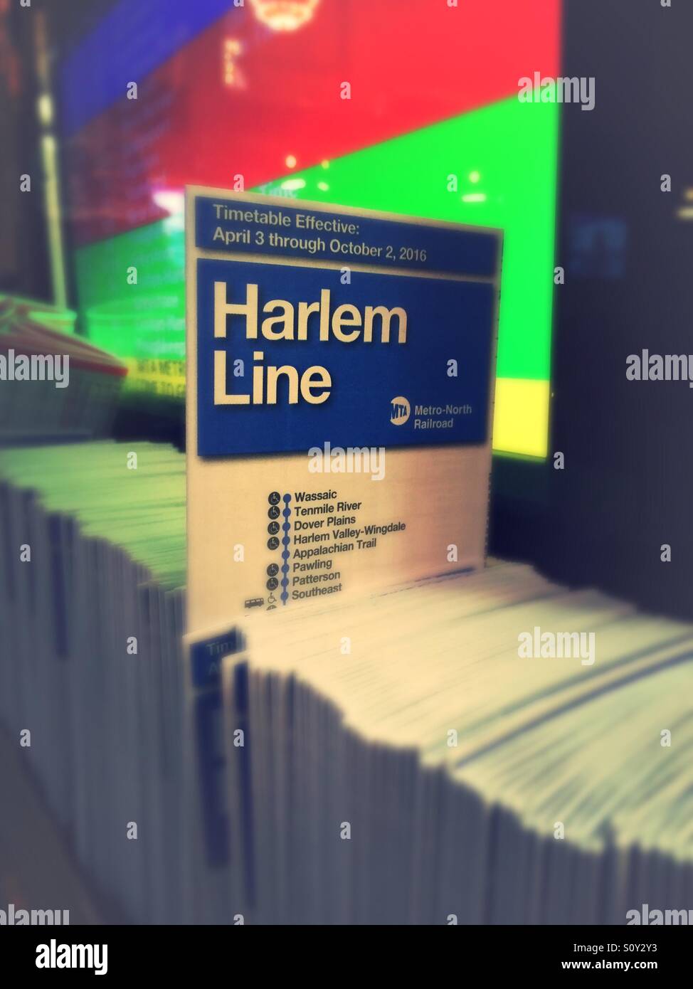 Timetable pamphlet for the Harlem line metro north of railroad at the information kiosk in Grand Central terminal, New York City. - Smartphone Captured Stock Image