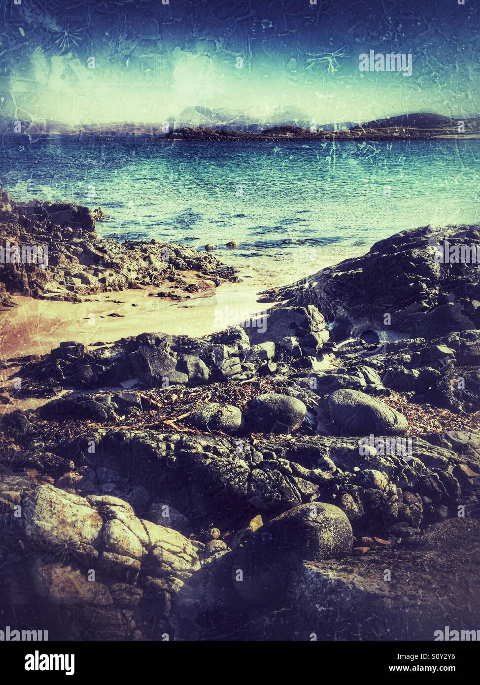 Sandy beach, rocks and crystal clear water at Achnasheen in the Scottish highlands - Smartphone Captured Stock Image