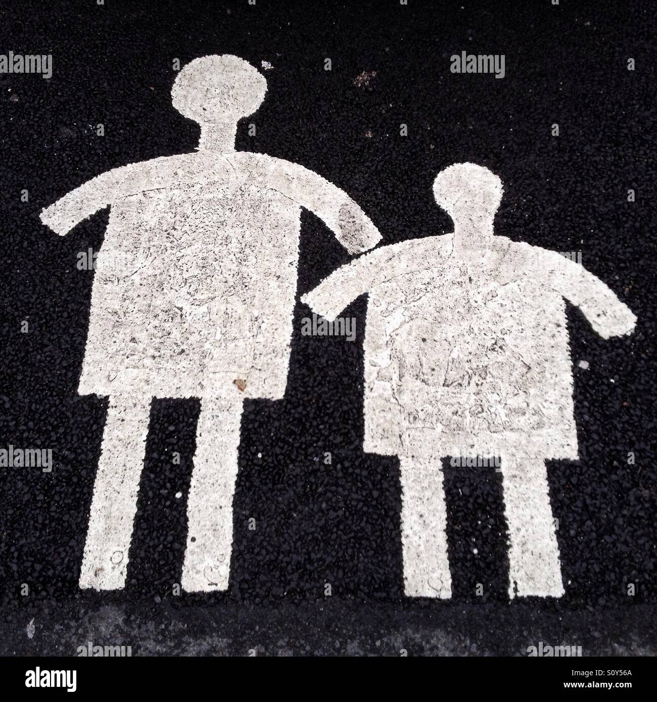 Obese mother and child markings in car park bay Stock Photo