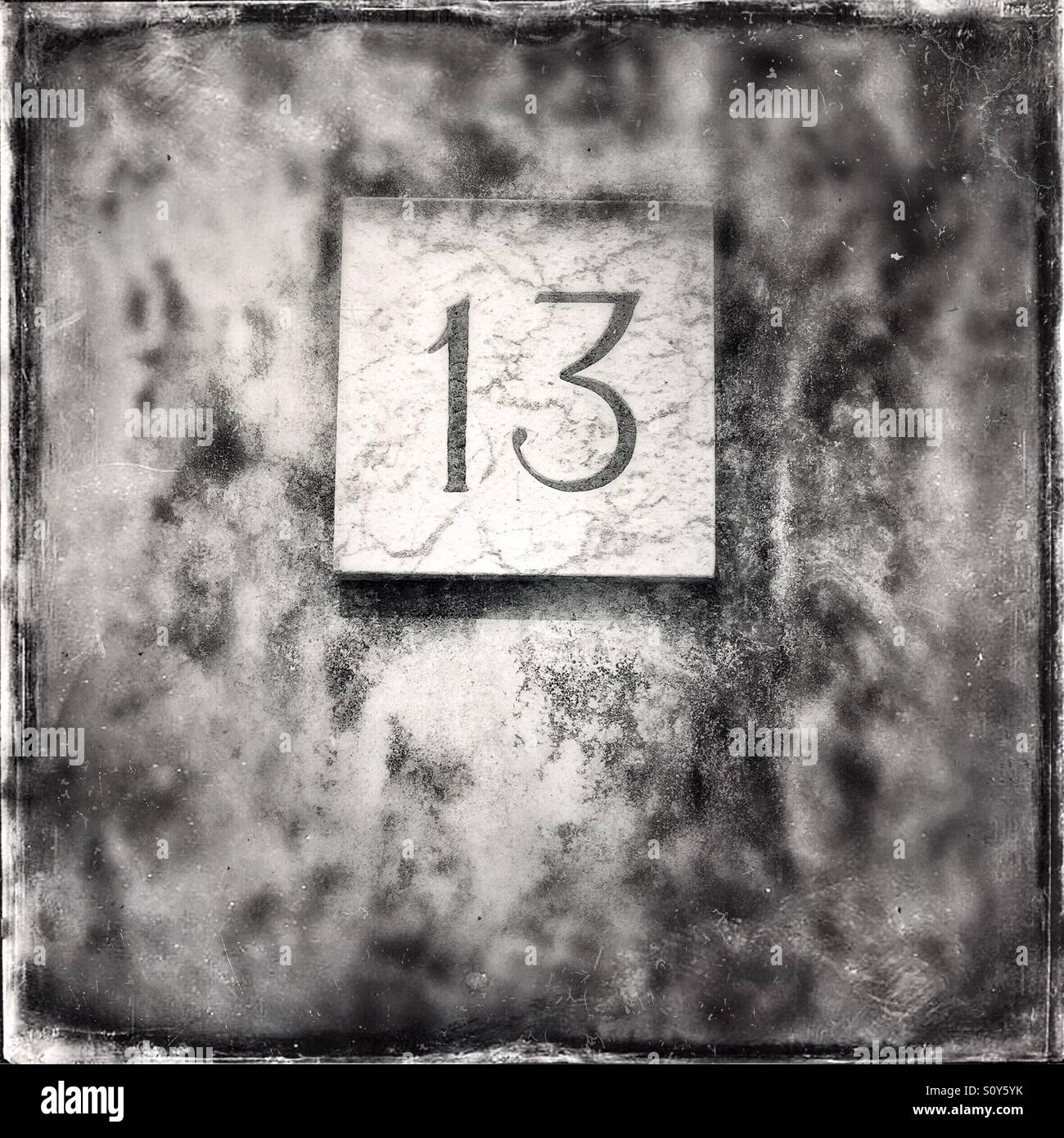 House number 13 on a dirty wall - Smartphone Captured Stock Image